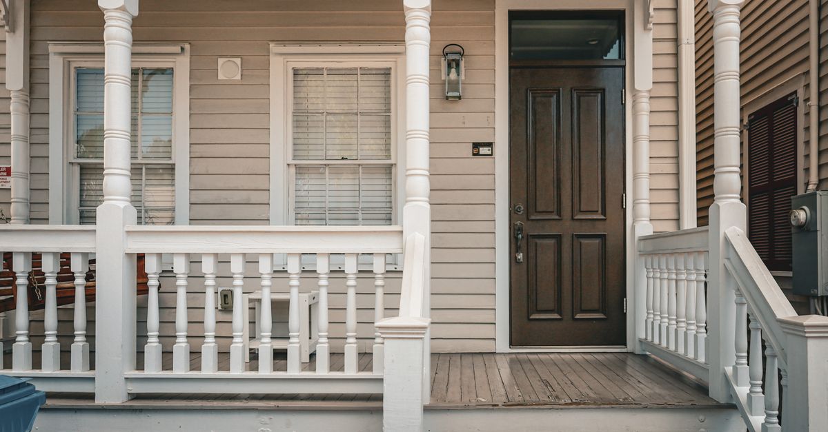 Beautifully renovated front porch with classic wooden railing