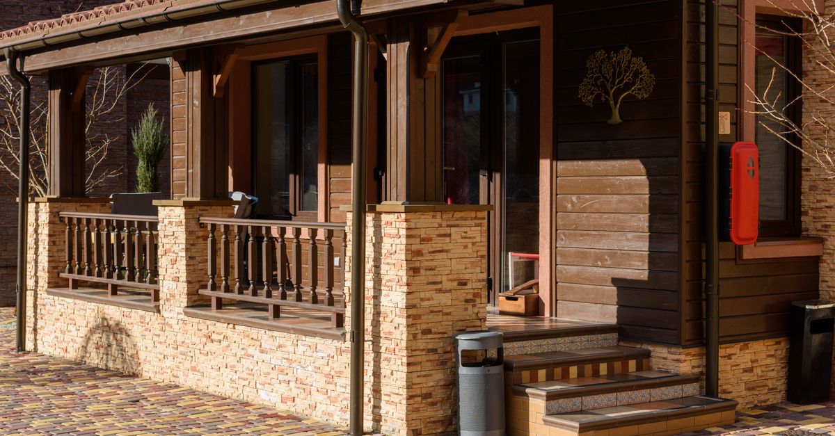 Beautiful wooden house exterior with stone accents and cozy porch